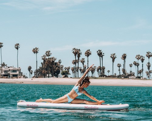 A woman stretching on a paddleboard
