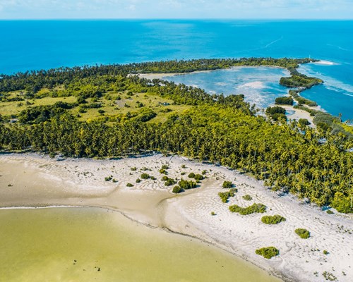 Narrow island with white sand beaches and palm tree forests